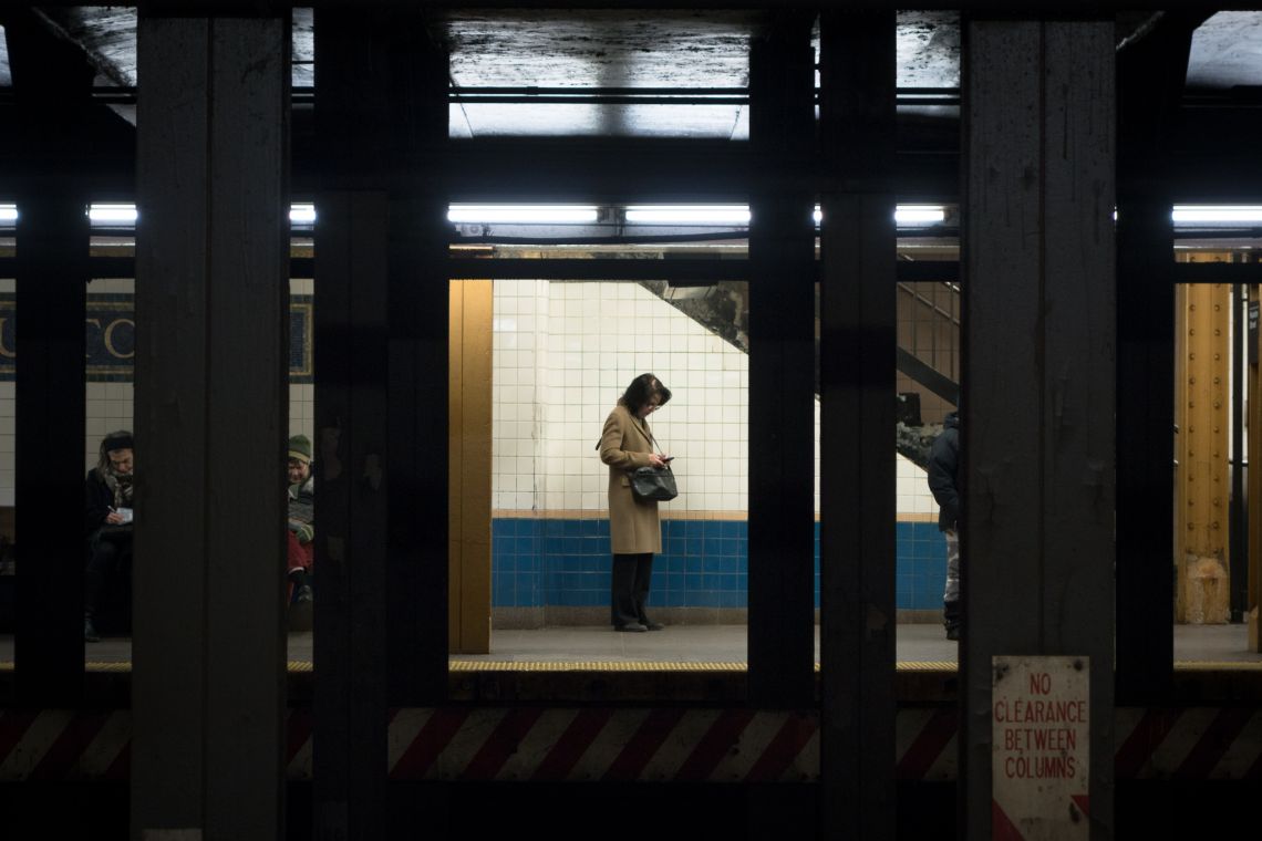 A passenger waits for the uptown 1 train