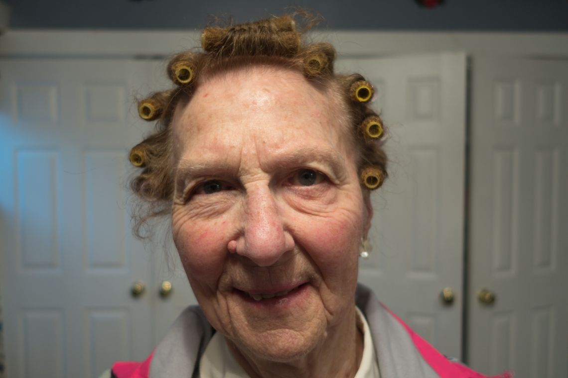 elderly woman with hair in rollers