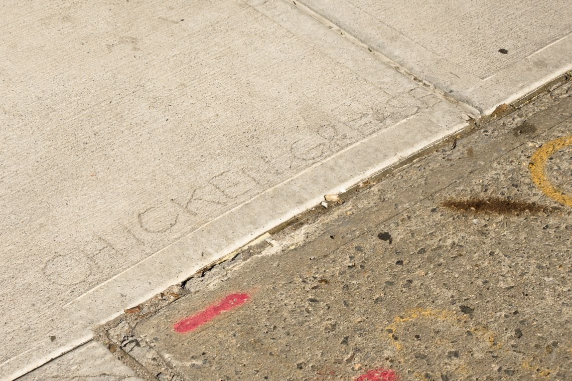 CHICKEN GREASE graffiti in sidewalk