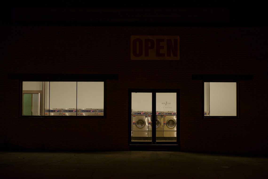 Laundromat storefront at night