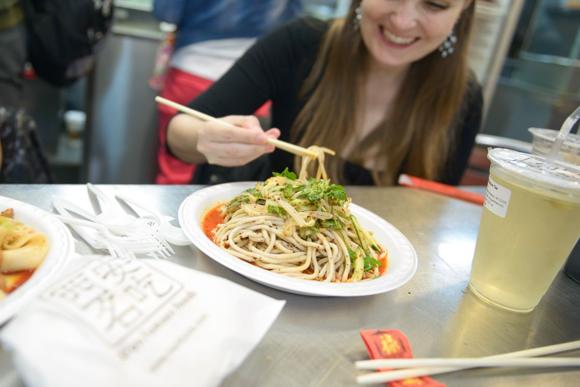 woman examining noodles xian famous