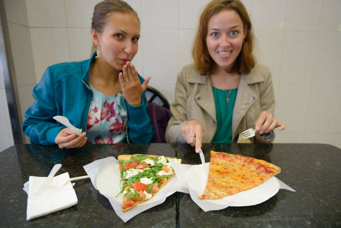 russian girls about to eat pizza slices