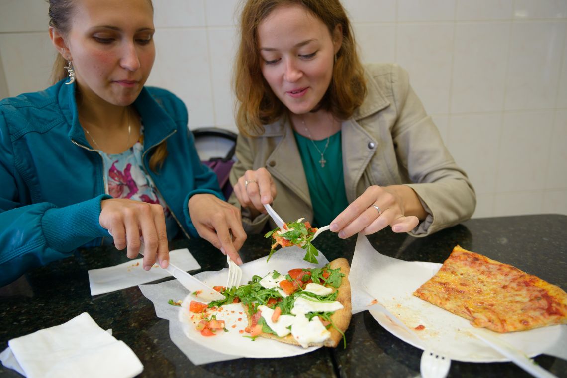 russian girls about to eat pizza slices