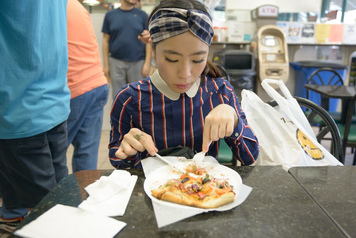 Japanese eating pizza williamsburg