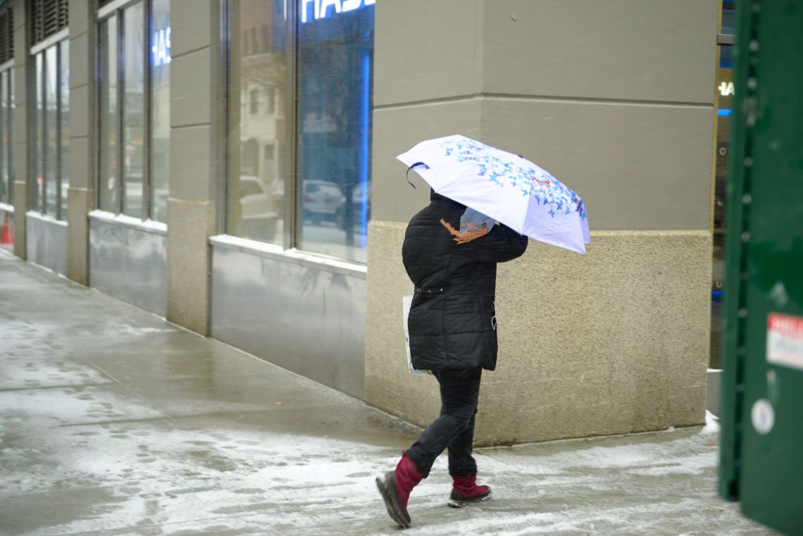 Woman blindly navigates the sidewalk.