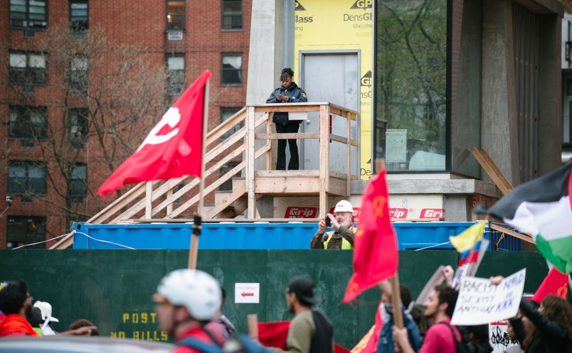 Man documenting the May Day March long 2nd Avenue