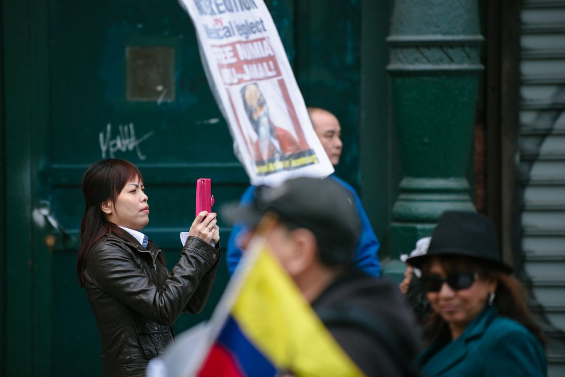 Woman documenting the May Day March long 2nd Avenue