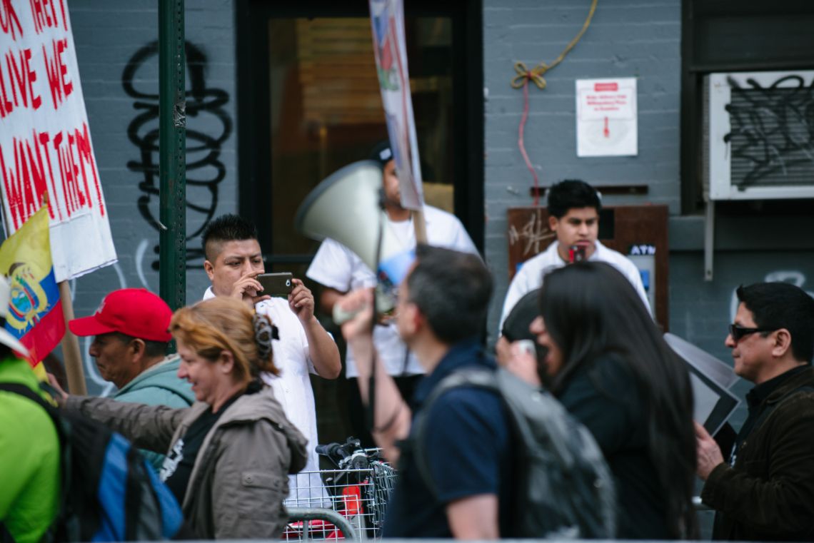 Man documenting the May Day March long 2nd Avenue