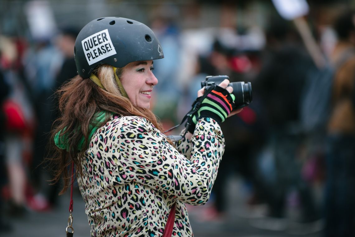 Woman documenting the May Day March long 2nd Avenue