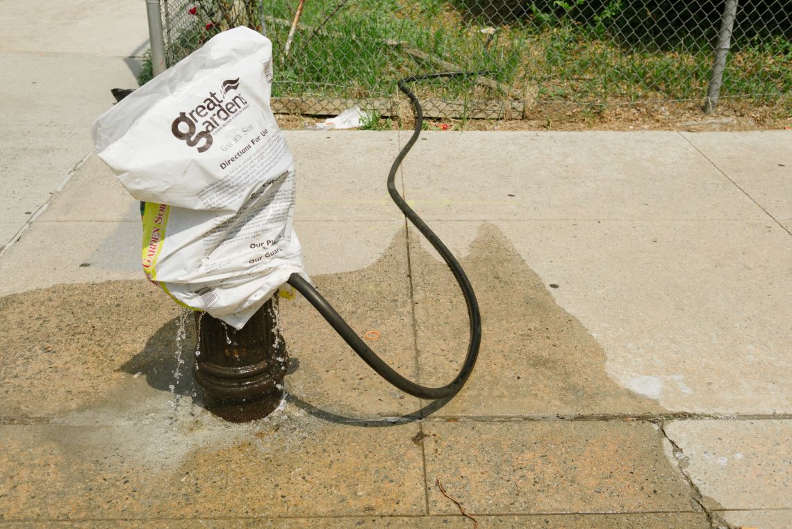 Water not directed through the hose runs off onto the sidewalk and into the street