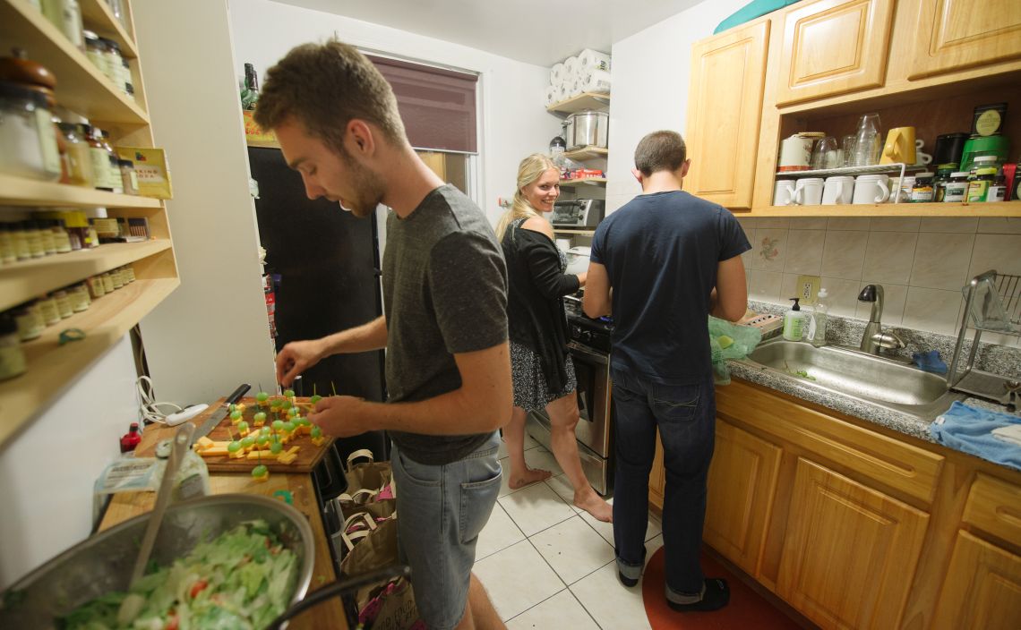 Surfers cooking in the kitchen