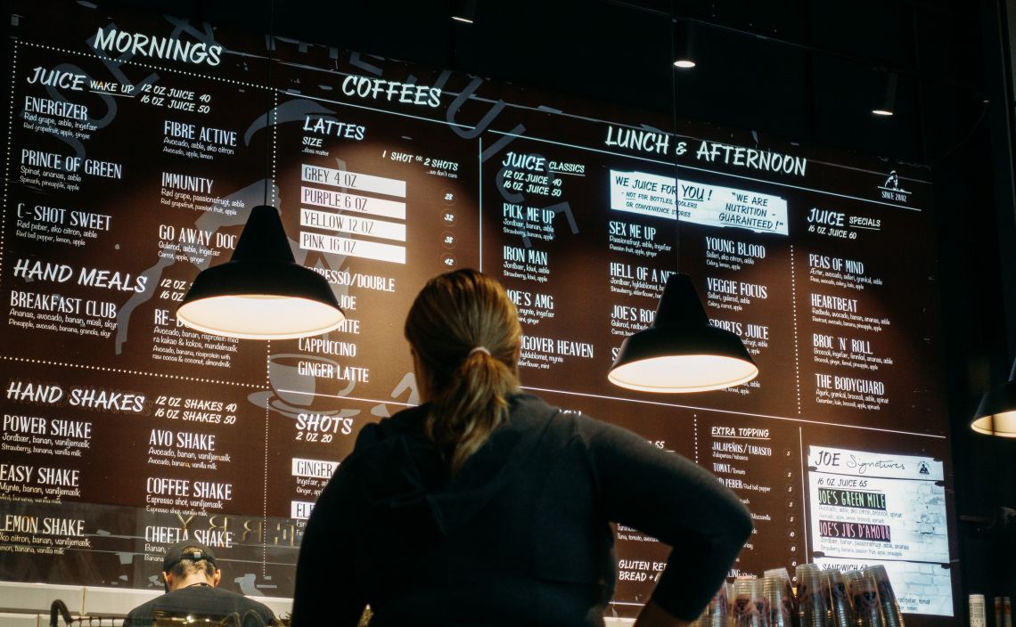 A woman waits for her smoothie at Joe and The Juice.