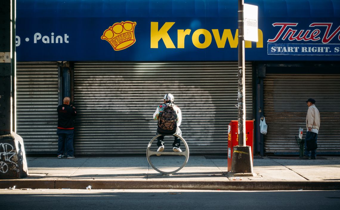 Man atop a ring, under a Krown.