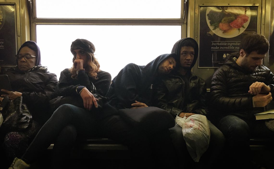 Commuter borrowing a shoulder on J Train in Brooklyn Bed-Stuy