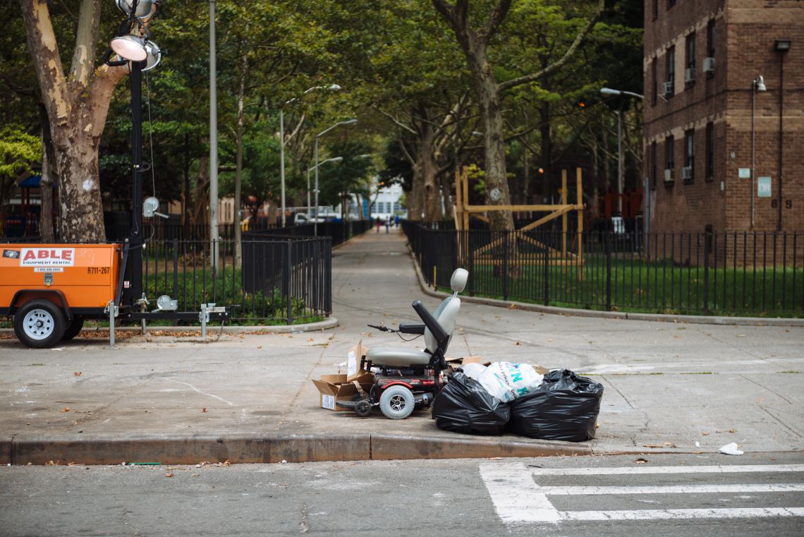 An electric scooter among other garbage