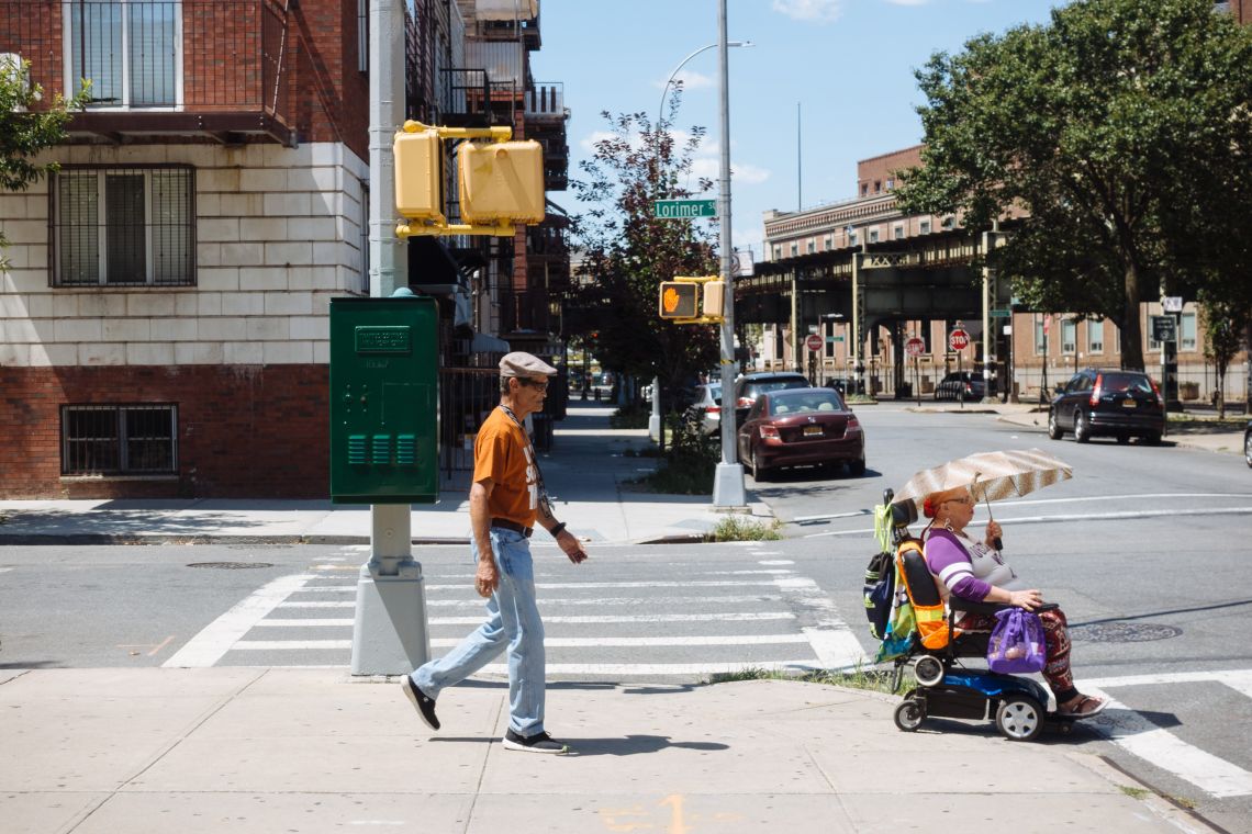 Woman in electric wheelchair with shade umbrella