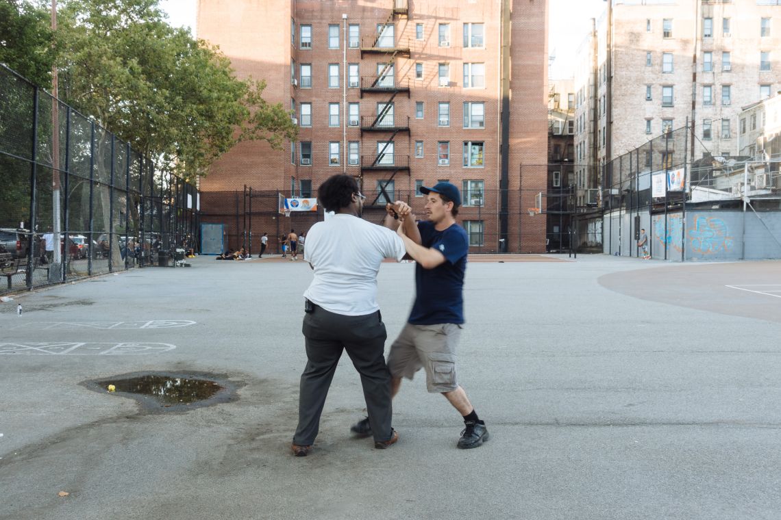 Men practice self-defense technique