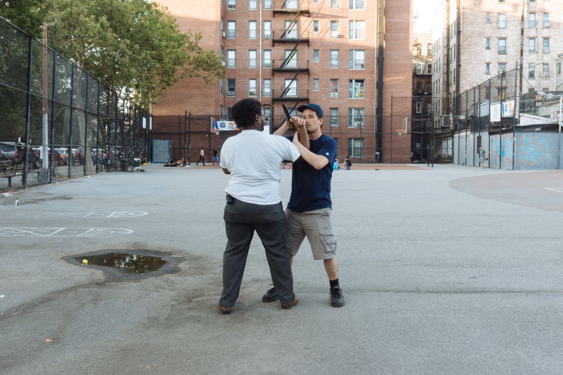 Men practice self-defense technique