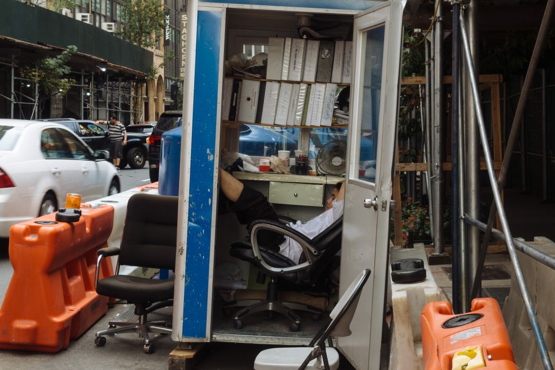 Young man kicking back in construction site office