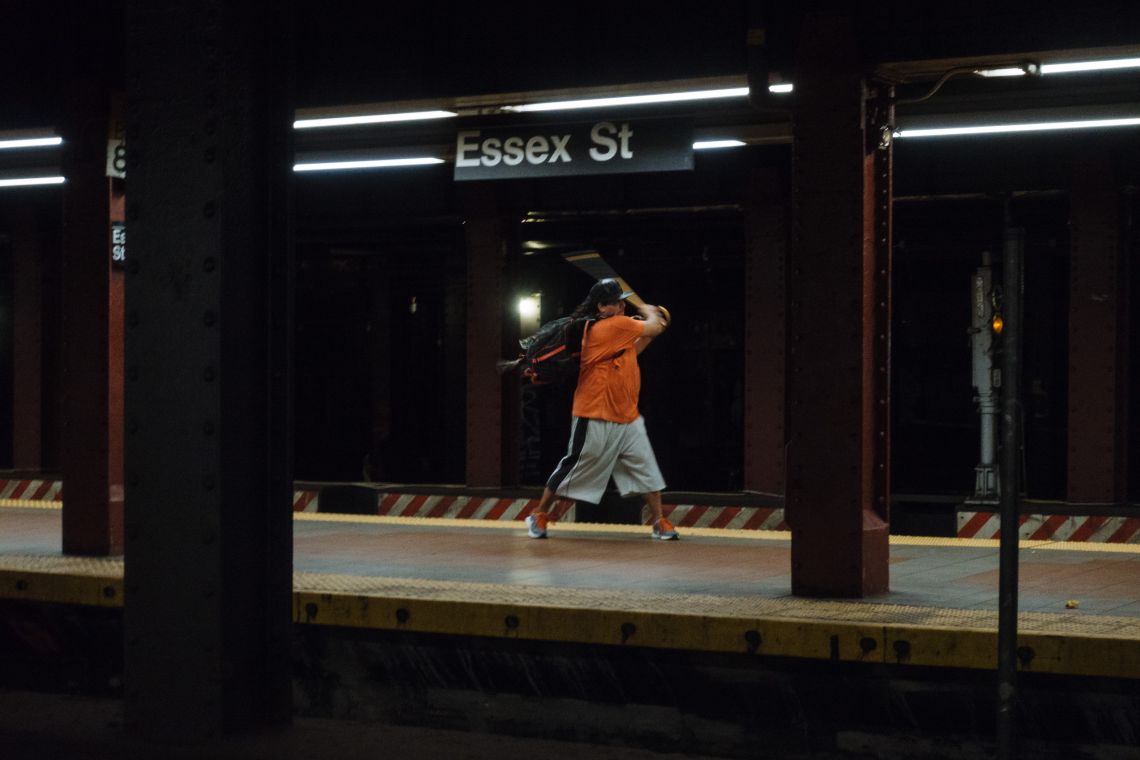 Man practicing batting swing with walking cane.