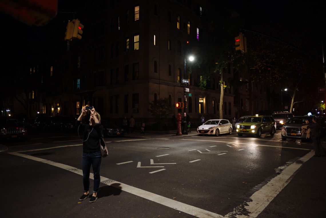 Passers-by took snapshots of the street signs at the intersection of Clinton and President