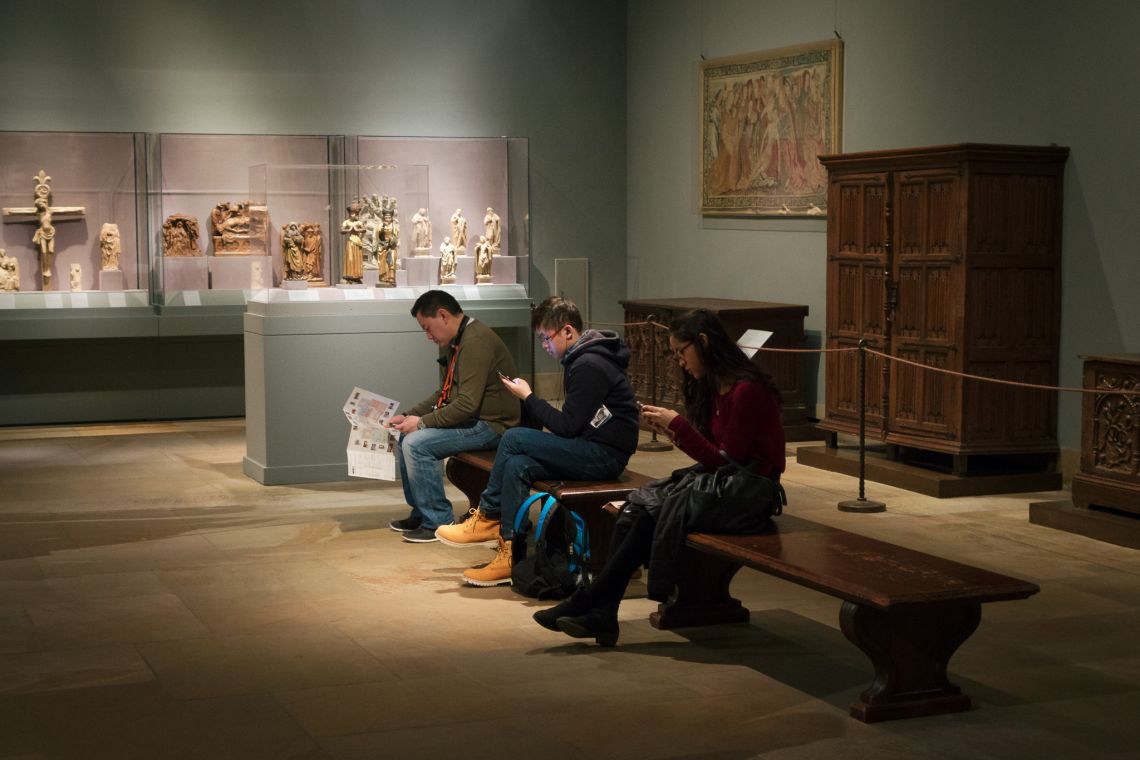 Museum patrons staring at smartphones
