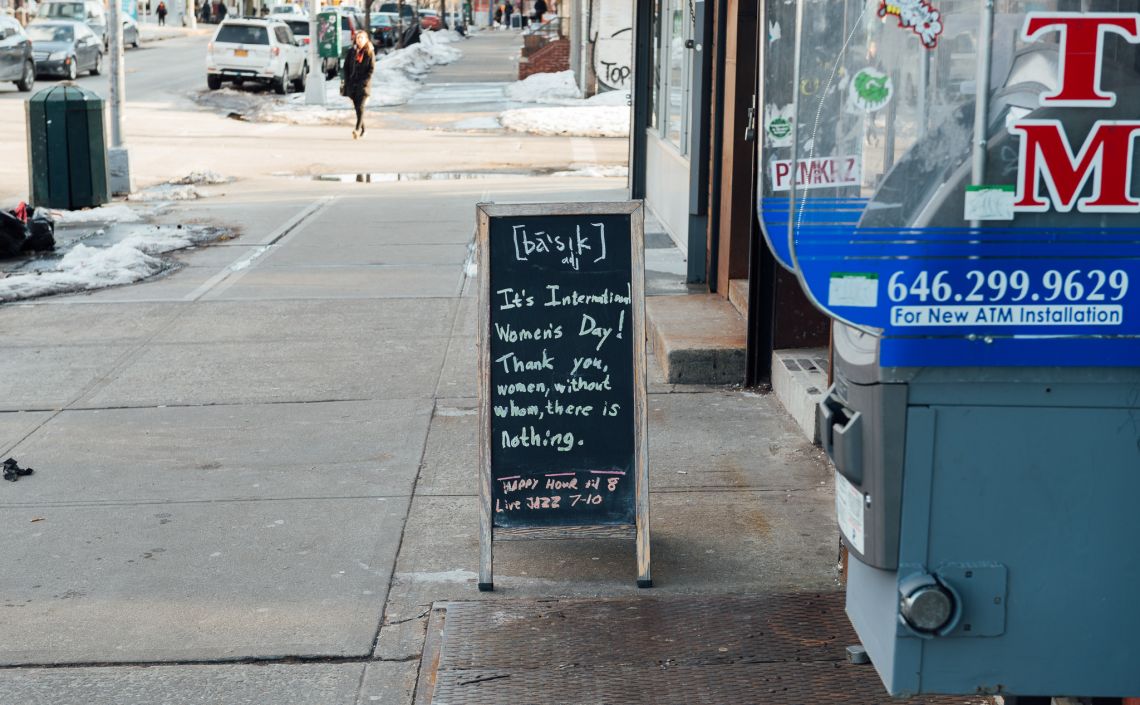Woman's Day sign in front of Basik bar in East Williamsburg
