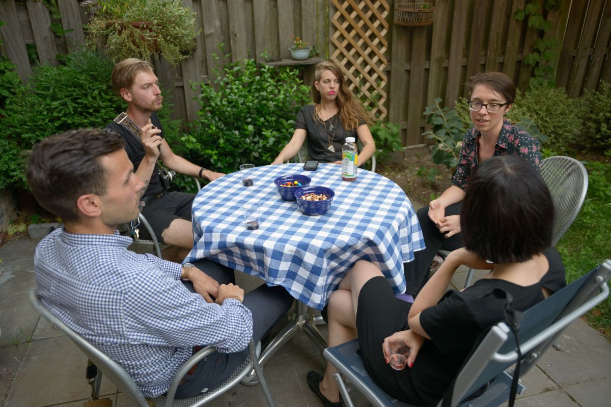 Guests mingle and chat outside. 