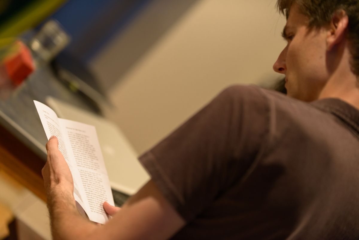 A guest reads the evening's program of events.