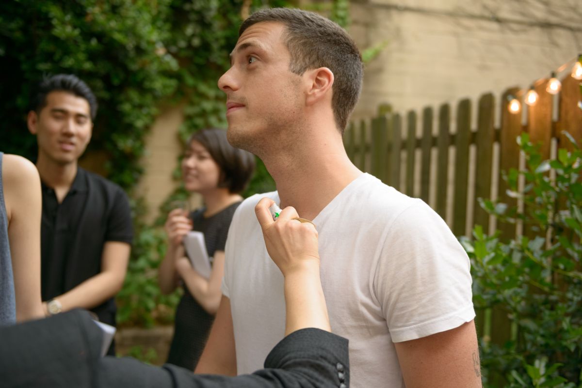 A guest is spritzed with a pheromone for men.