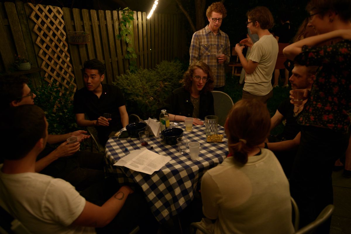 Evening sets in and guests continue to chat and mingle.