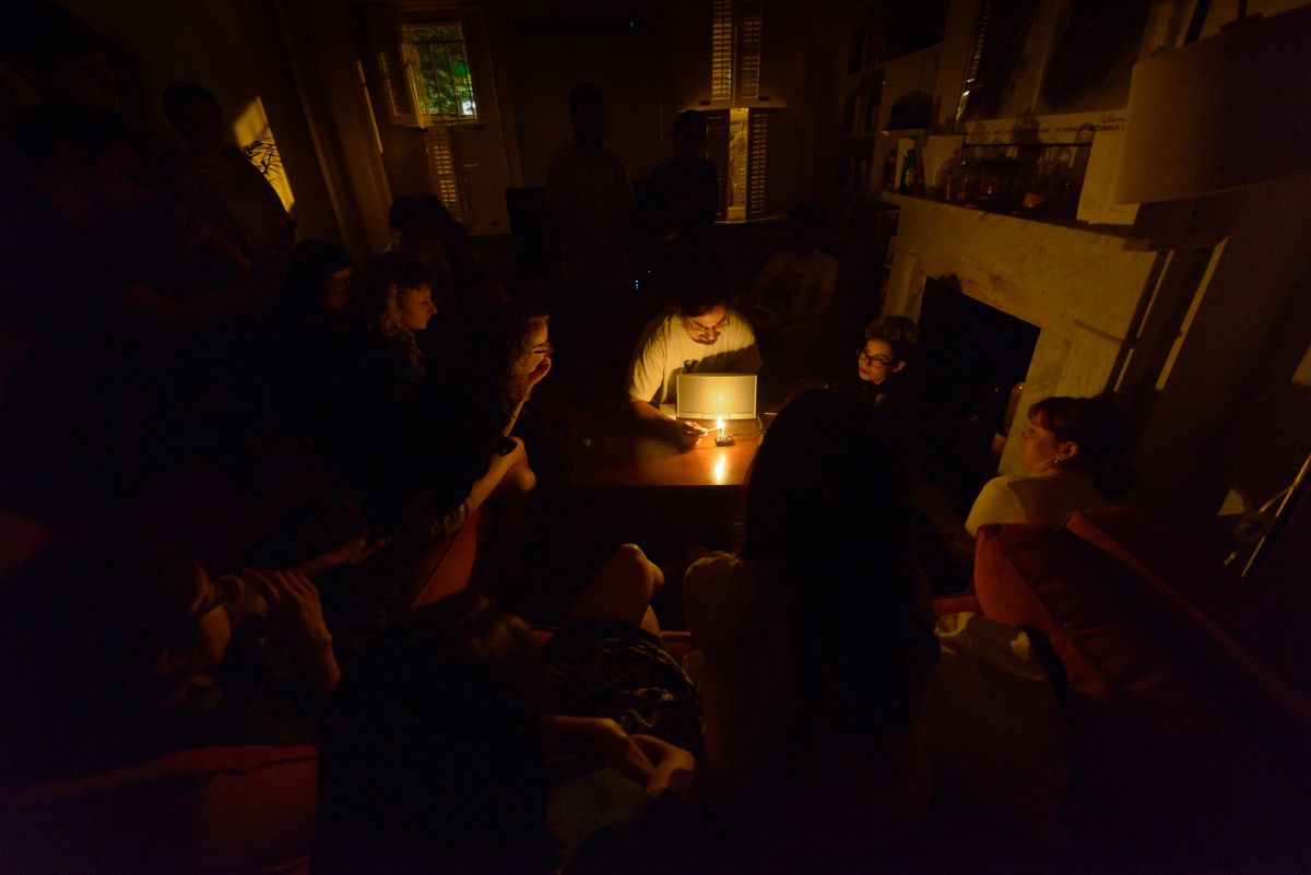 Daniel Fishkin begins his second piece of the night by lighting a candle