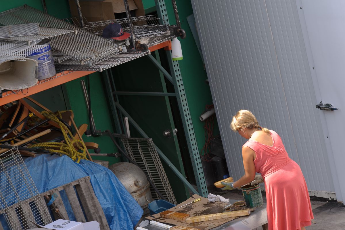 Ah. The woman hand-laquering the bread for display purposes.