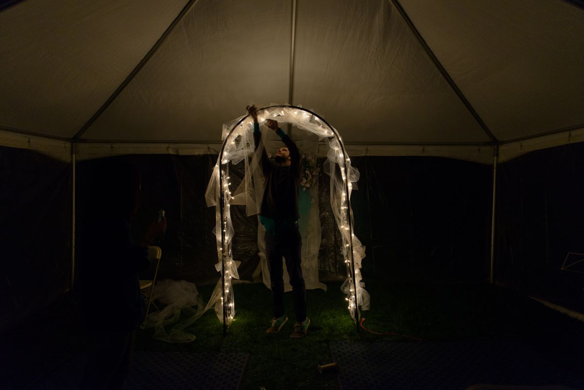 man decorating wedding archway