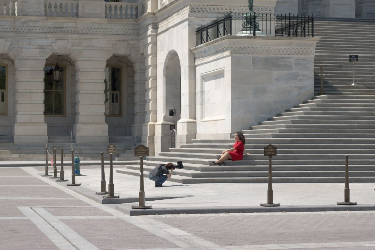 woman red dress on steps capitol building with photographer