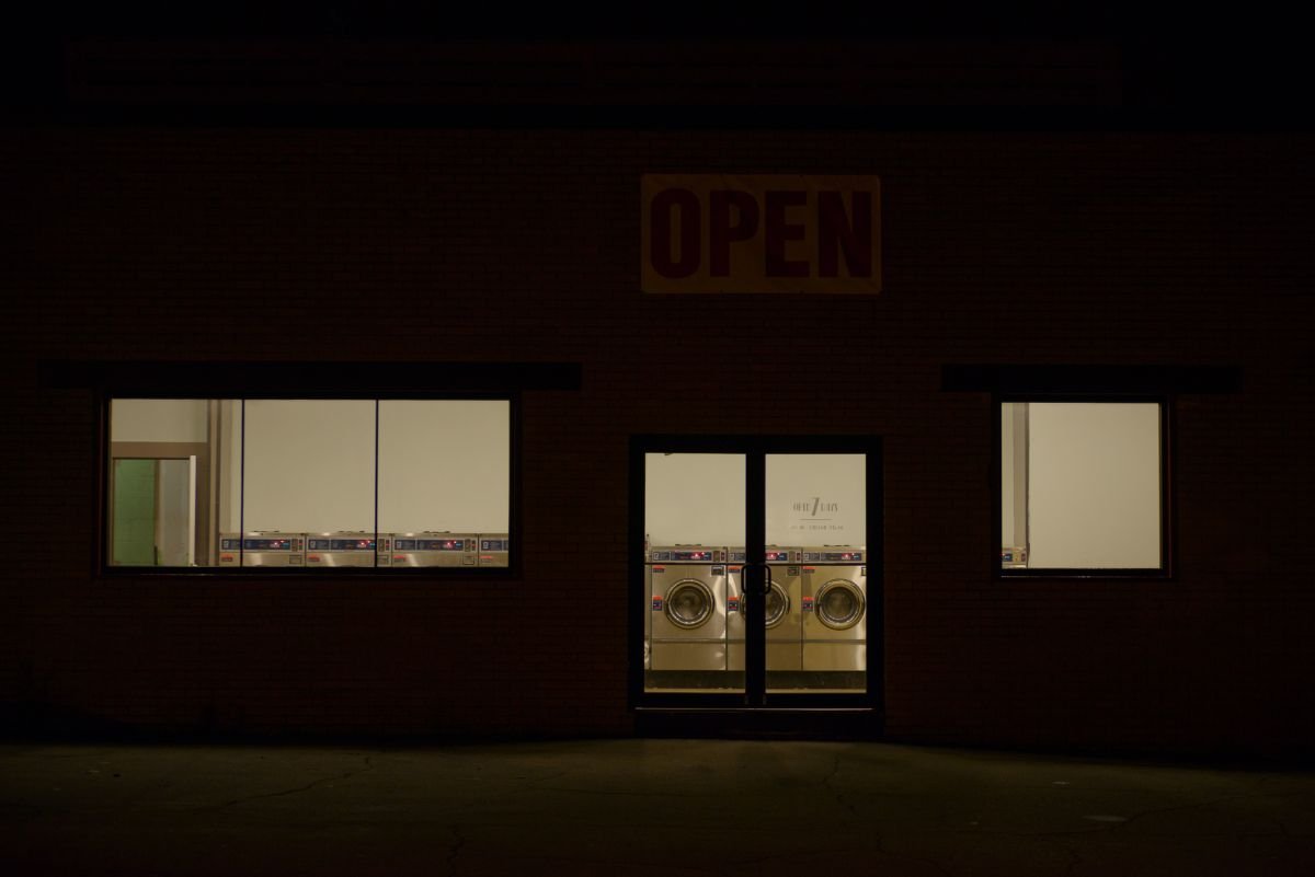 Laundromat storefront at night