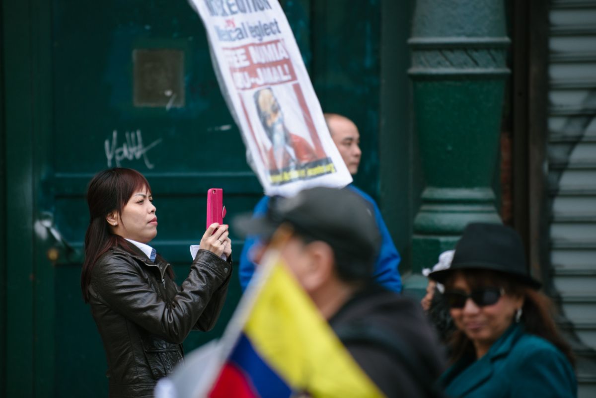 Woman documenting the May Day March long 2nd Avenue