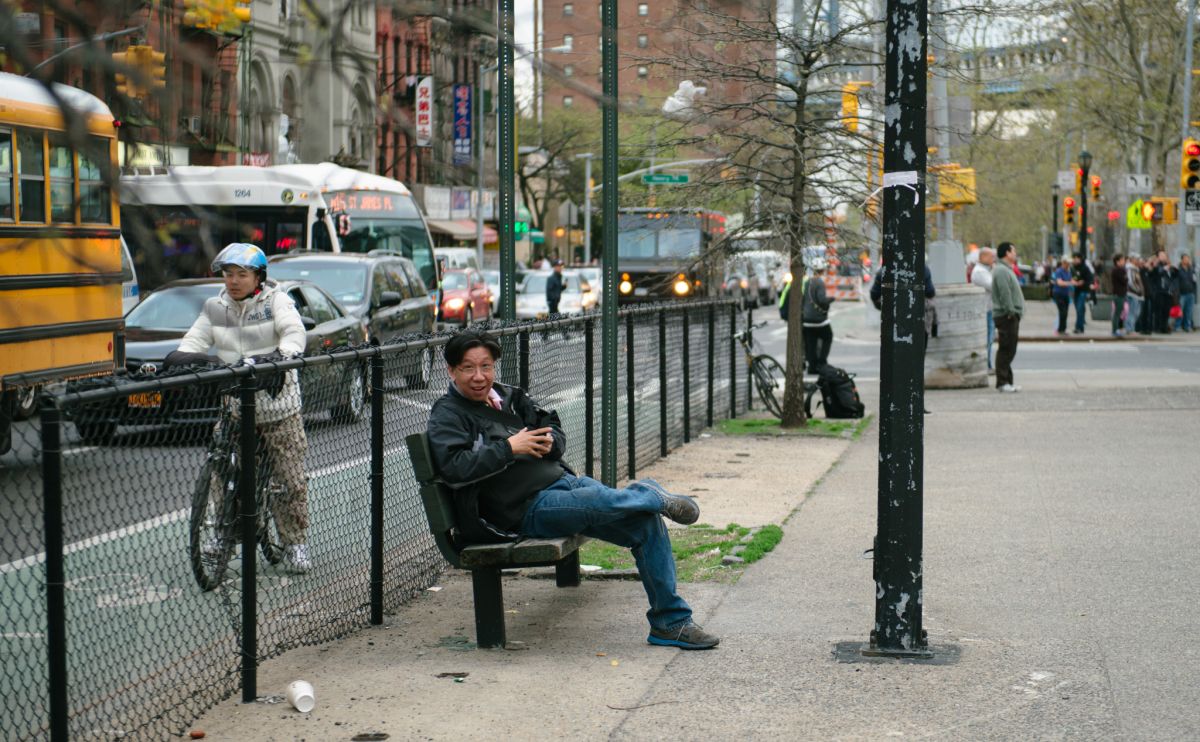 Man documenting the May Day March long 2nd Avenue