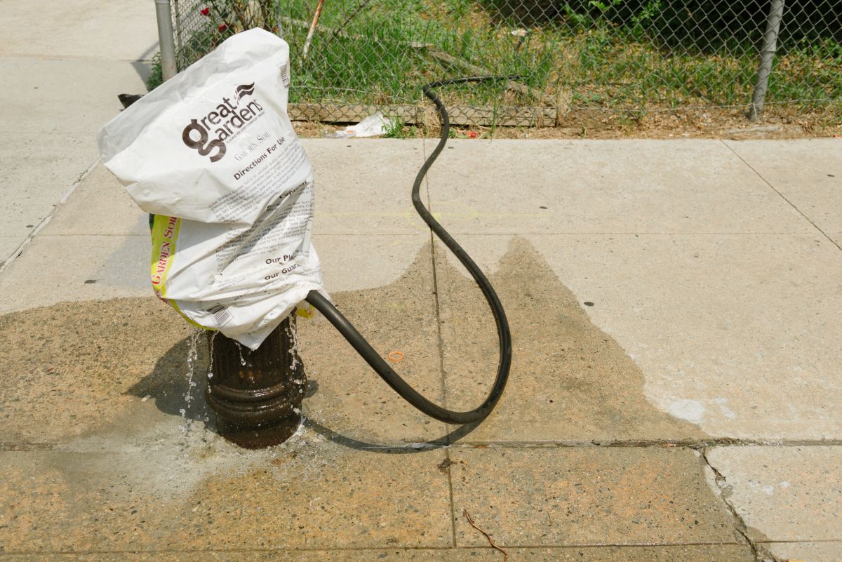 Water not directed through the hose runs off onto the sidewalk and into the street