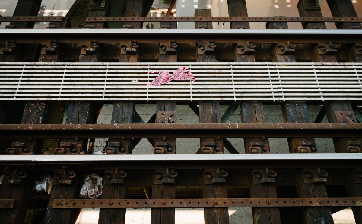 A pink leopard print bra or bikini top on train tracks
