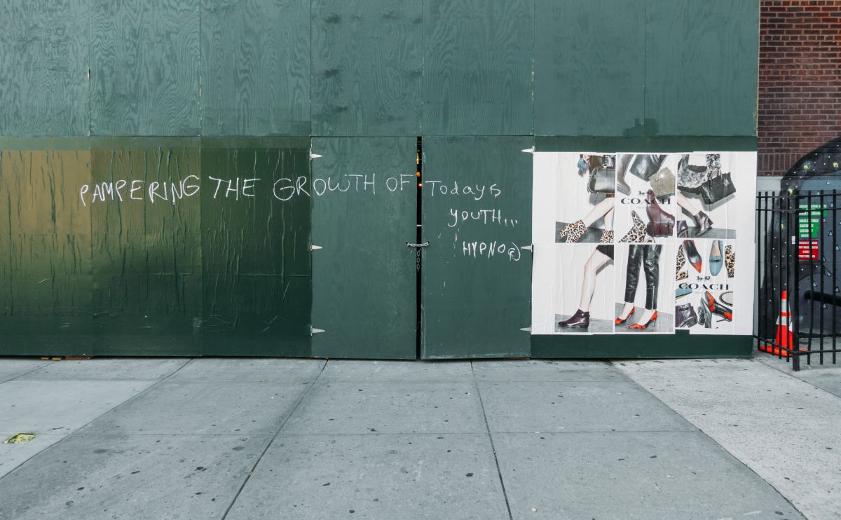 Signage and scrawl on a work site wall
