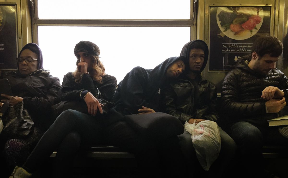 Commuter borrowing a shoulder on J Train in Brooklyn Bed-Stuy