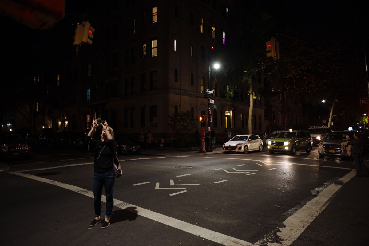 Passers-by took snapshots of the street signs at the intersection of Clinton and President