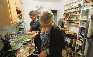 Surfers cooking in the kitchen