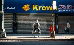 Man atop a ring, under a Krown.