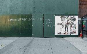 Signage and scrawl on a work site wall