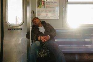 Subway sleeper on a Manhattan bound J train