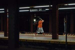Man practicing batting swing with walking cane.