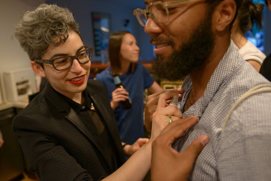 A guest is spritzed with pheromone for men.