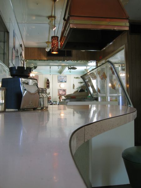 Streamlined countertop, curious old couple eating Sunday brunch.